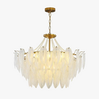 Ornate modern crystal chandelier with vintage tassels, feather accents, and soft glowing elegance.