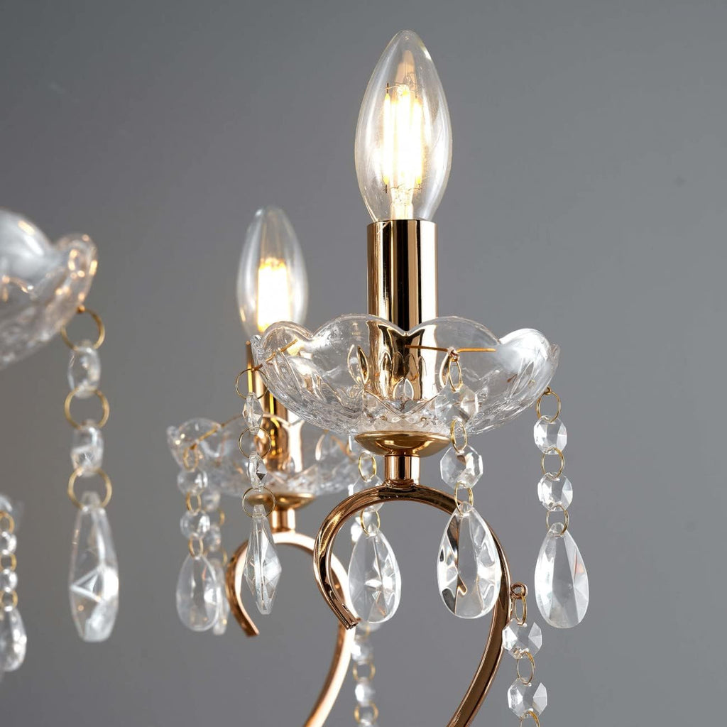 Maison Ornate Rose Gold Baroque Crystal Chandelier with eight candle bulbs and hanging crystals.