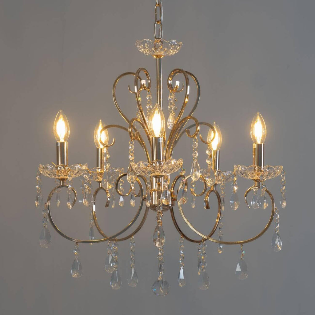 The Maison Ornate Baroque Chandelier has gold tassels, metal arms, and sparkling crystals.
