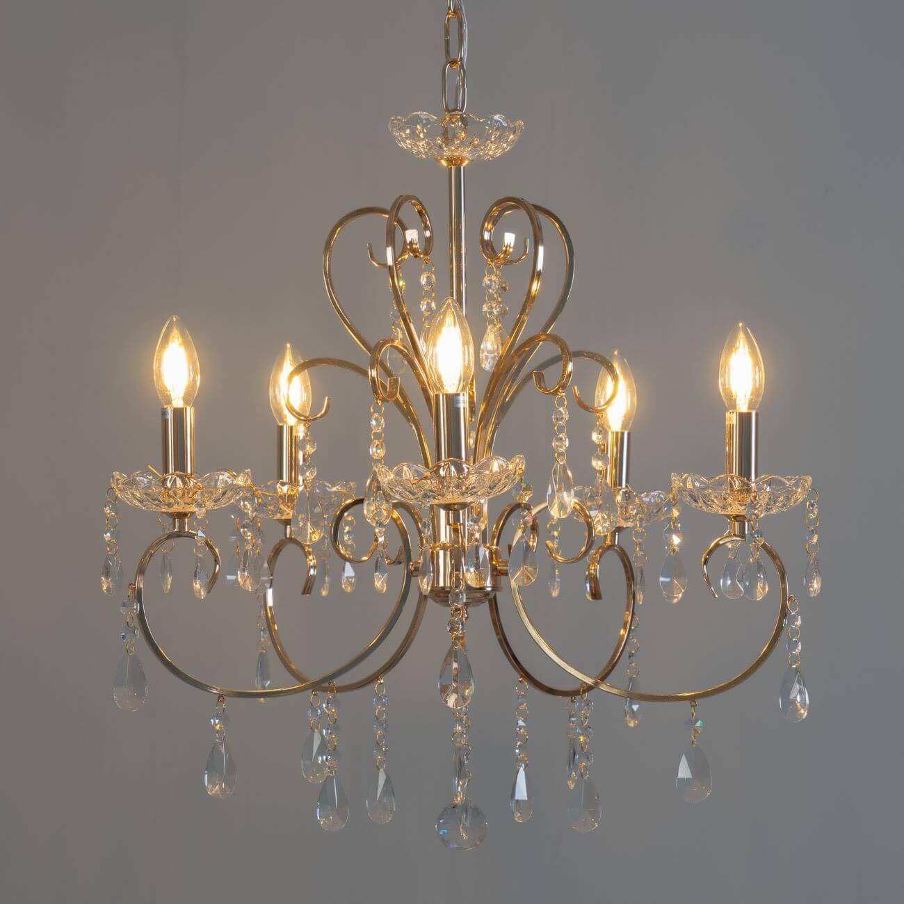 The Maison Ornate Baroque Chandelier has gold tassels, metal arms, and sparkling crystals.