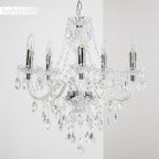 Chrome-finished chandelier with five candle-style lights, crystal droplets, and beads in modern design.