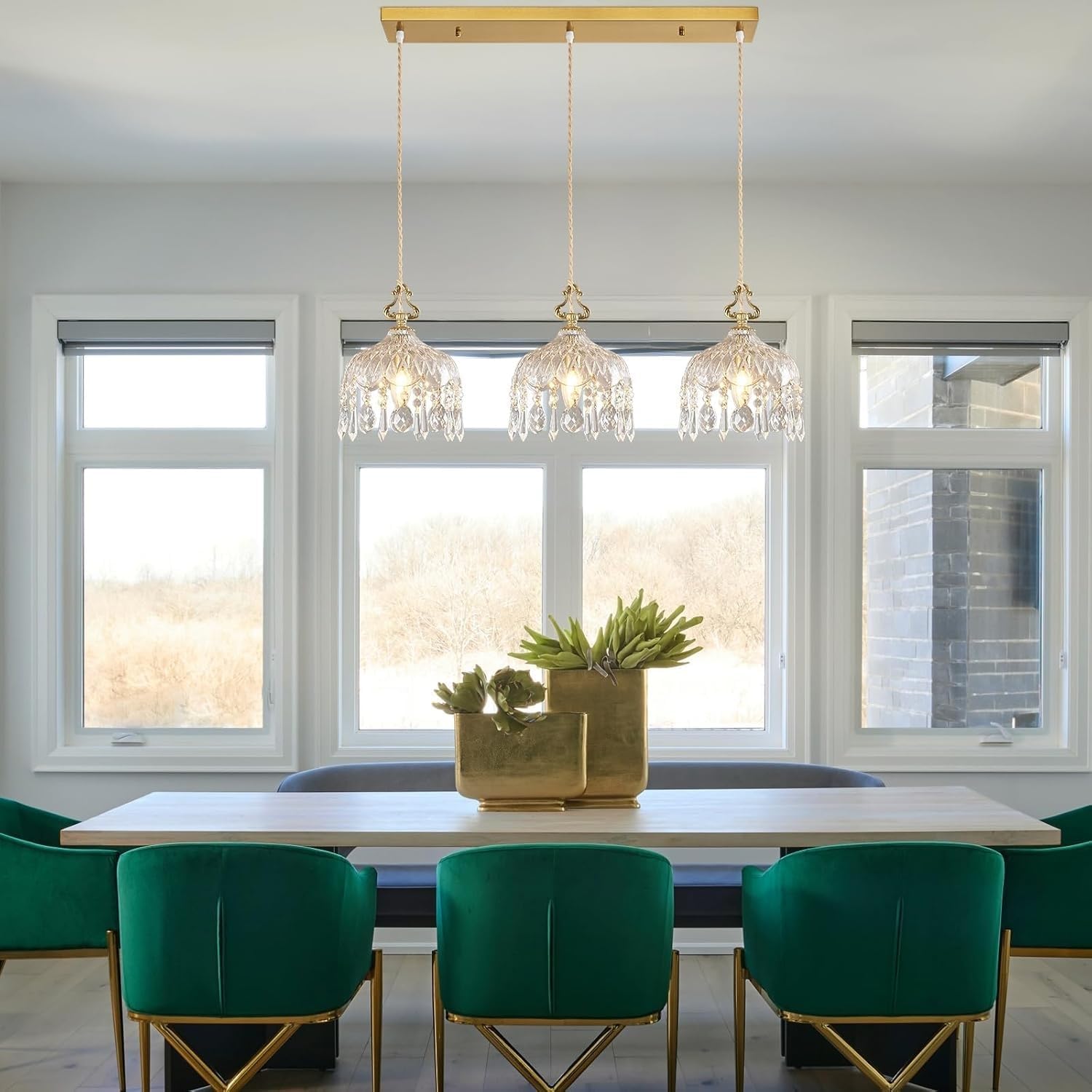 Three Maison Ornate Elegant Adjustable Brass Crystal Pendant Lights, featuring brass frames and sparkling crystal accents.
