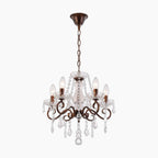 Bronze five-arm chandelier with candle-style bulbs and clear crystal accents, vintage rustic design.