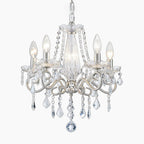 Sparkling Art Deco chandelier with crystals, silver accents, nickel finish, and five candle bulbs.
