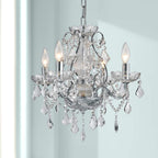 The Maison Ornate Modern Chrome chandelier features 4 lights, ornate metal arms, and crystal pendants.