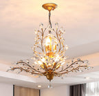 Maison Ornate K9 Crystal Chandelier with gold, black, silver branches and leaf-shaped faceted crystals.