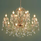 Maison Ornate 15-arm rose gold baroque chandelier with glass droplets and illuminated bulbs.