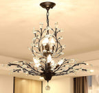 Maison Ornate K9 Crystal Chandelier in gold, black, and silver with crystal leaves and exposed E14 bulbs.