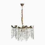 Tiered chandelier with gold frame, acrylic crystal prisms, and brown fabric-wrapped cord for elegance.
