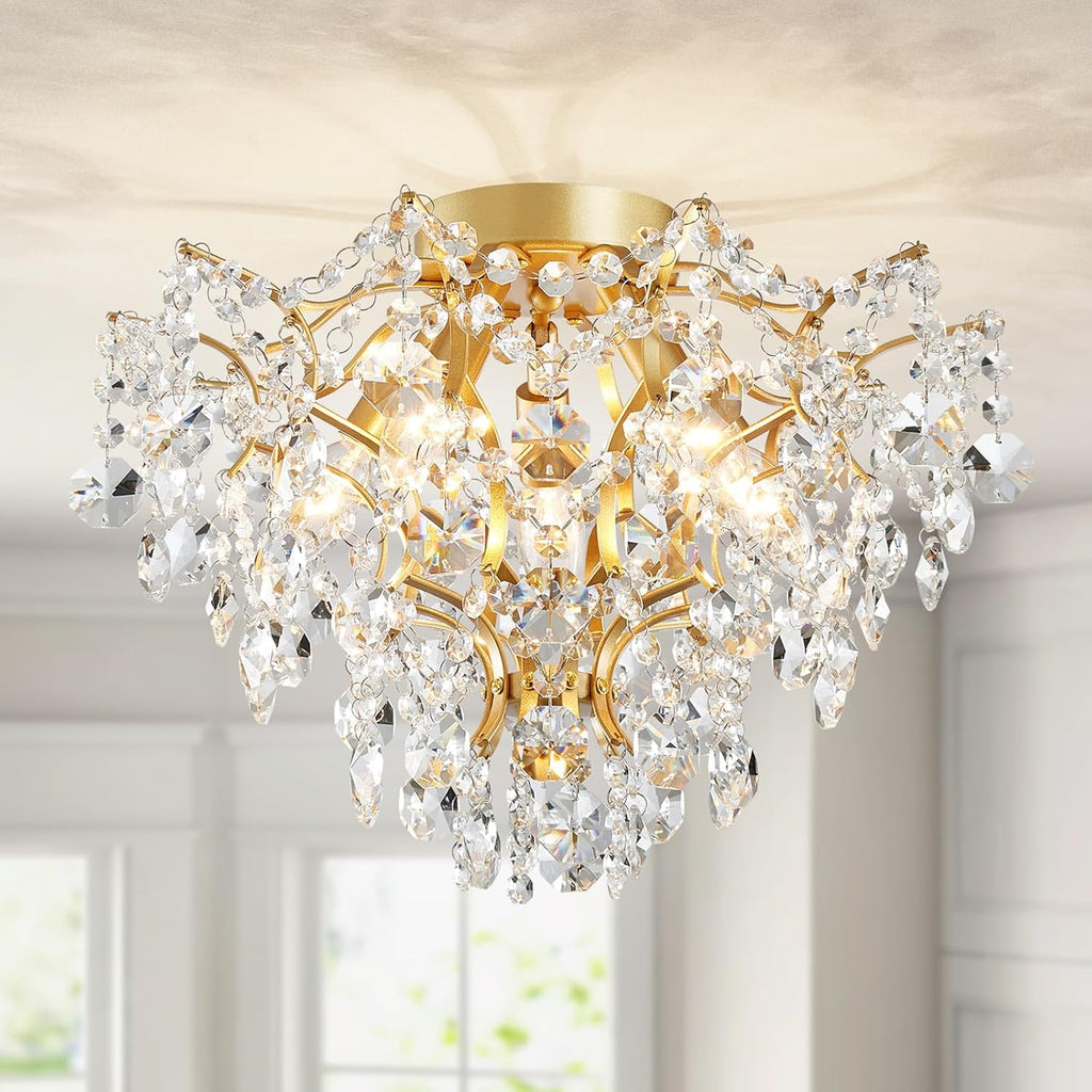 Ornate modern gold chandelier with five lights, intricate metalwork, and cascading crystal prisms.