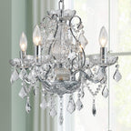 Chrome chandelier with five candle lights, glass arms, and crystal pendants for a luxurious look.