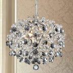 Tiered chandelier with clear and smoky crystals, intricate silver metalwork, raindrop-inspired modern design.