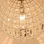 Close-up of Maison Ornate's bronze crystal ball chandelier, metallic frame, sparkling faceted K9 crystals.
