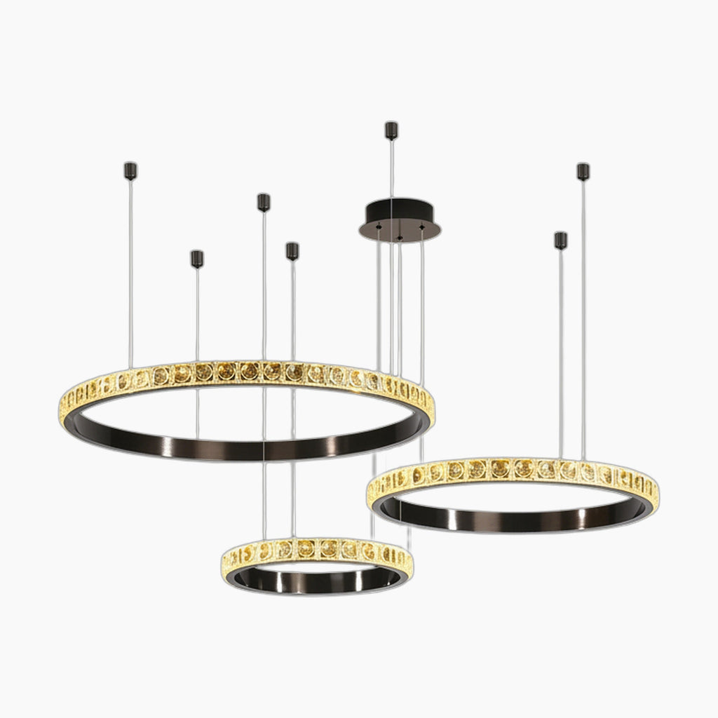 Three gold-trimmed crystal rings suspended from a black mount form this modern luxury chandelier.