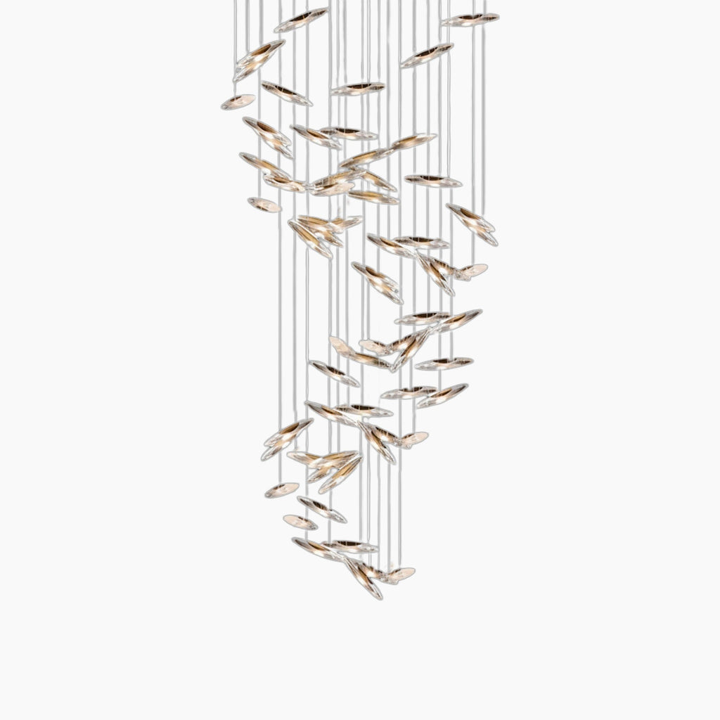 Cascading glass or crystal discs hang at varied heights on thin wires in this modern chandelier.