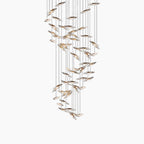 Cascading glass or crystal discs hang at varied heights on thin wires in this modern chandelier.