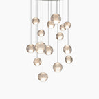 Maison Ornate Crystal Sphere Chandelier with rotating LED, glass spheres hang at varied lengths.