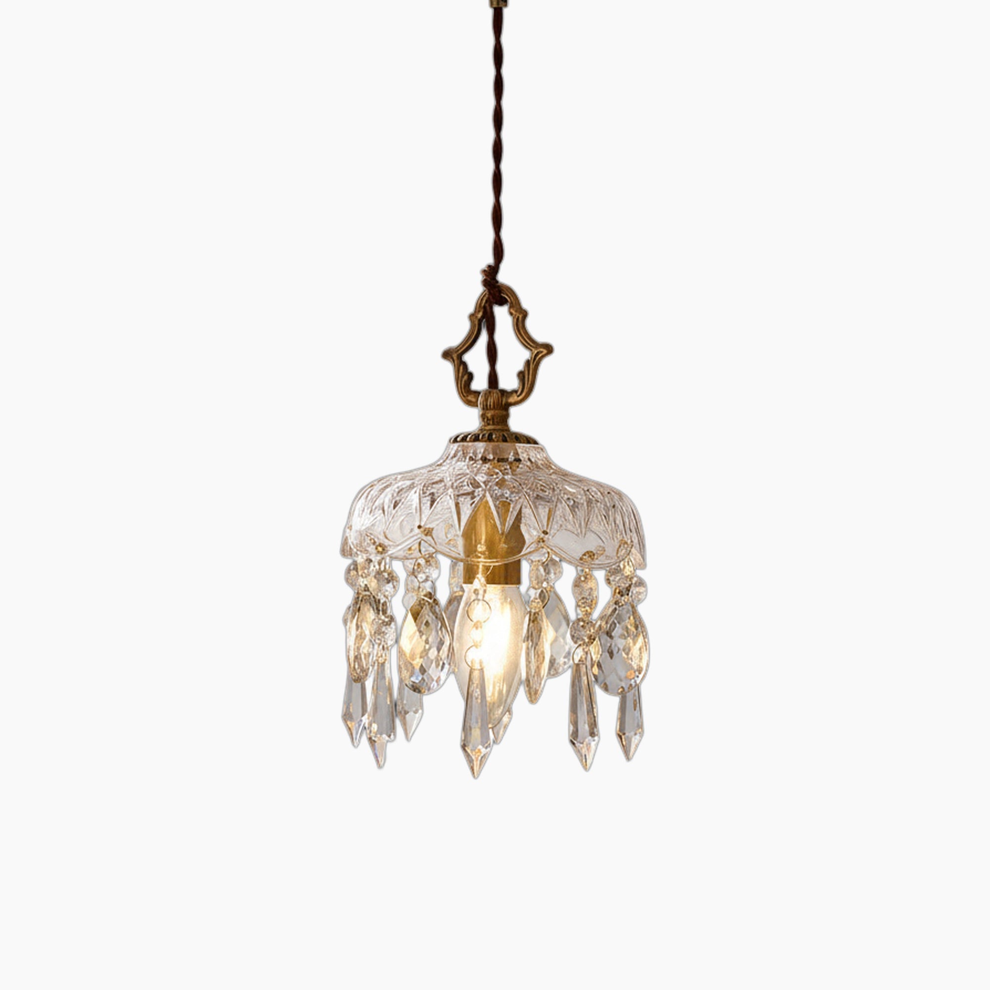 Brass and crystal pendant chandelier with clear glass shade and hanging prisms, product-focused view.