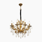 Elegant baroque chandelier with 8 candle lights, ornate curved arms, and cascading crystal pendants.