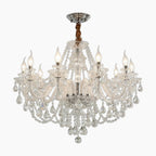 Maison Ornate 6-arm chandelier with curved arms, candle bulbs, and sparkling crystal prisms.