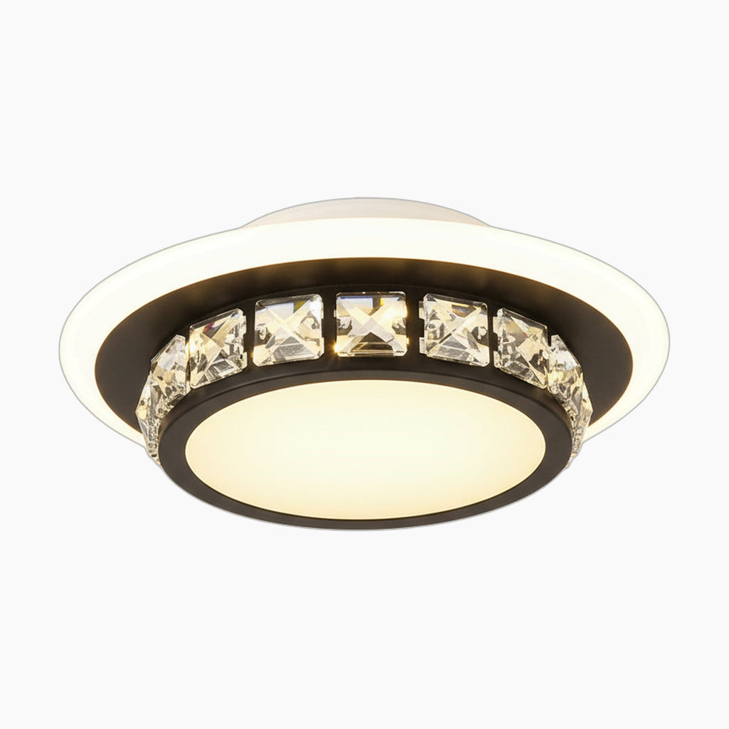 Modern chandelier with black circular ring, square crystal accents, and frosted diffuser emitting warm light.
