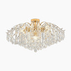 Gold and silver branch chandelier with clear crystal teardrops, LED lighting, modern luxury design.