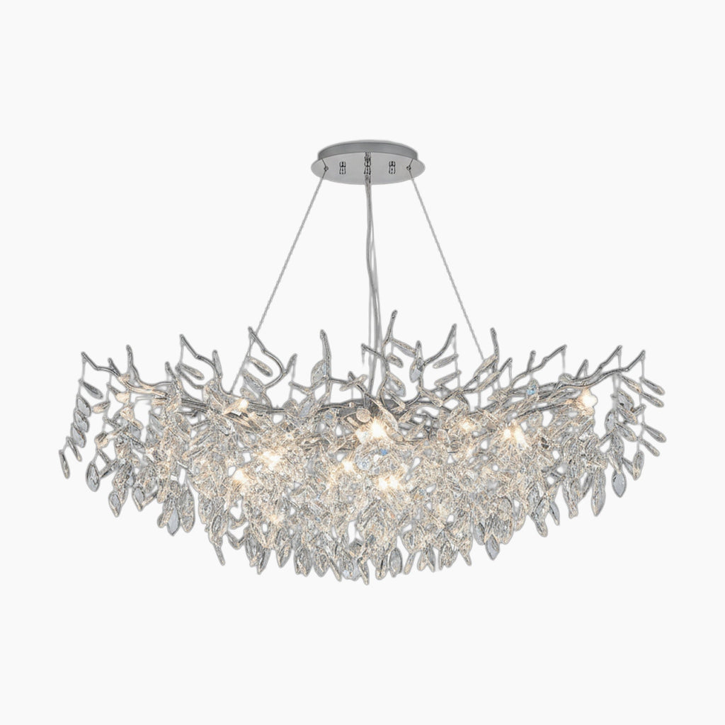 Polished aluminum chandelier with crystal leaf branches, suspended by four wires, emits elegant LED light.