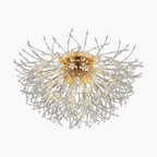 Modern crystal chandelier with a gold center, silver branches, tassels, and abstract burst shape.