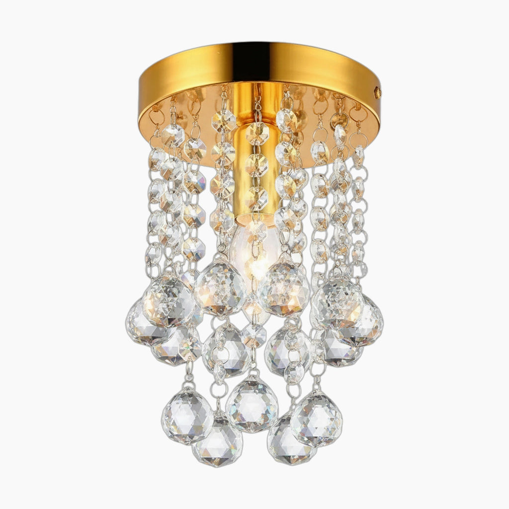 Ornate crystal chandelier with gold tassels, teardrop pendants, and center bulb in modern style.
