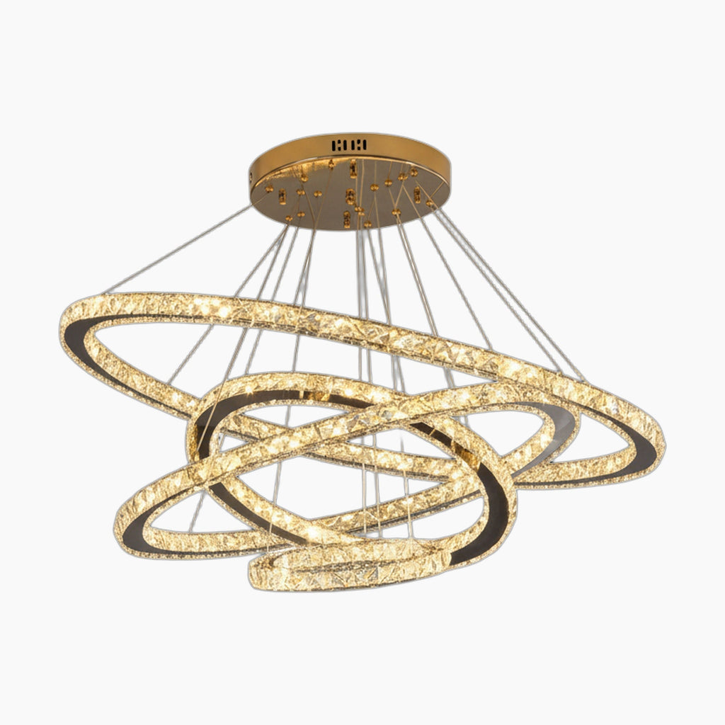 Intertwined gold and crystal LED rings form a modern, dimmable chandelier on a round base.