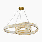 LED chandelier with intertwined crystal rings, brass mount, and thin suspension cables; sleek modern design.