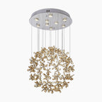 Modern chrome-base chandelier with gold flower LED accents and crystal ball design, suspended by wires.
