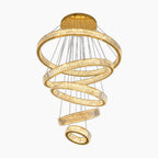 Five spiral gold-accented crystal chandelier rings are suspended by thin wires in a modern design.