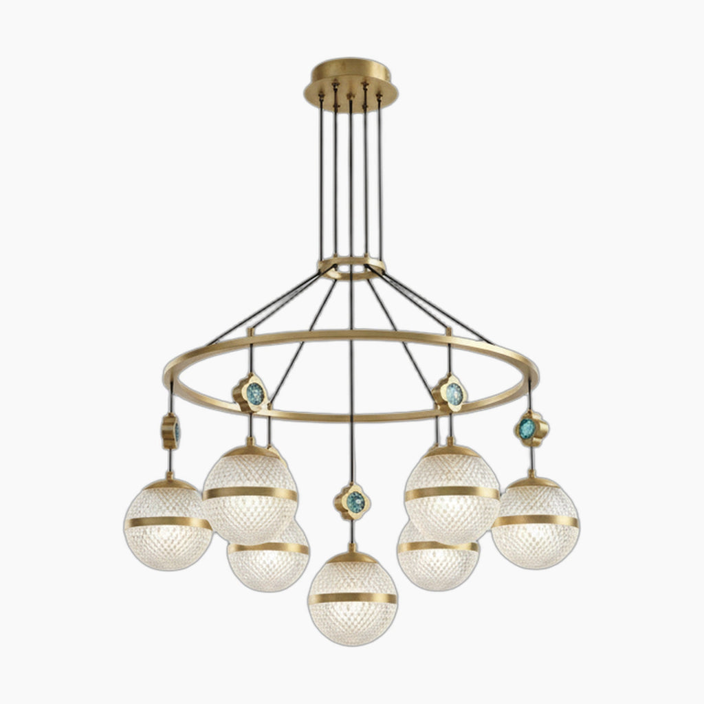 Seven textured glass globes hang from a gold circular frame with turquoise accents; modern chandelier.