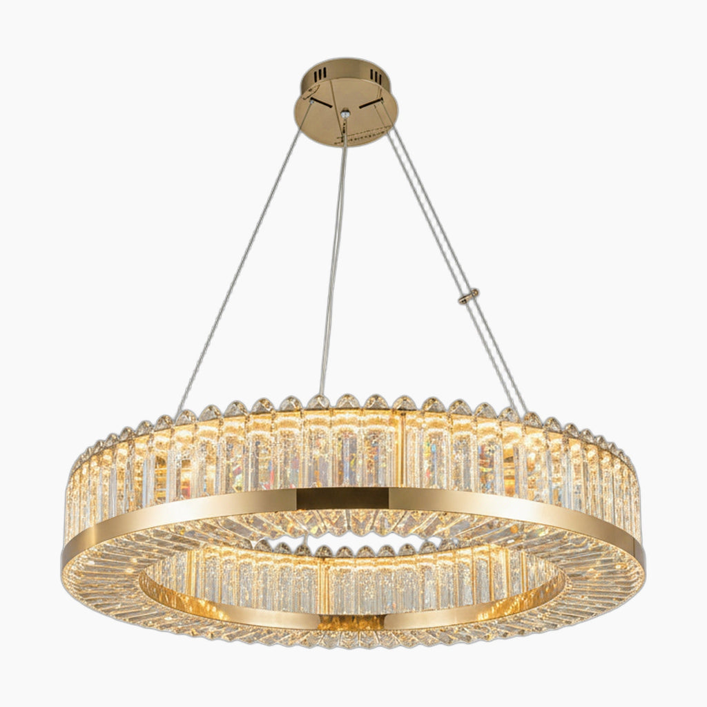 Geometric circular chandelier with clear crystal prisms, suspended by cables, emits elegant warm light.