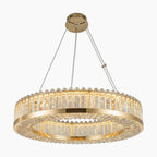 Geometric circular chandelier with clear crystal prisms, suspended by cables, emits elegant warm light.