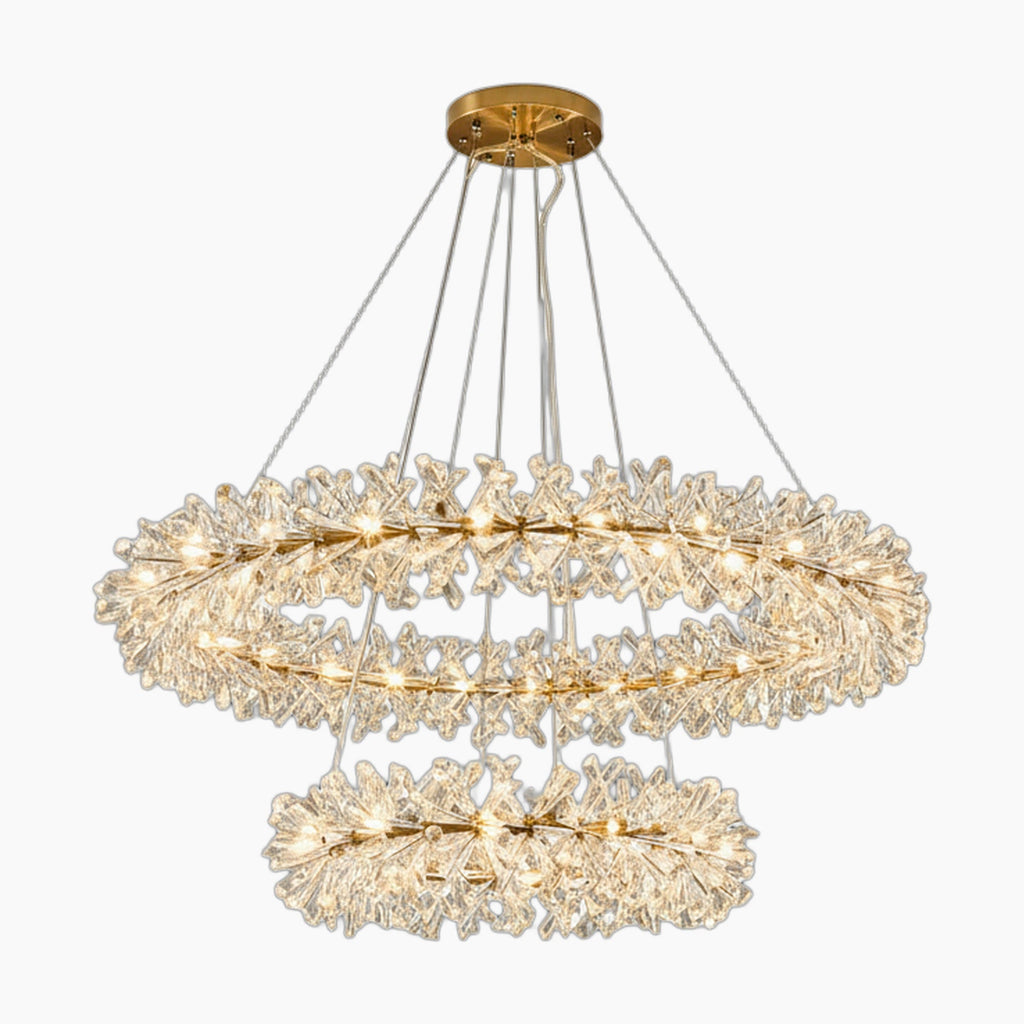 Gold-tone chandelier with dual rings, clear leaf-shaped crystals, and floral accents, elegantly suspended.