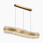 Modern LED chandelier with wavy gold band, adjustable wires, and sparkling clear crystal accents.
