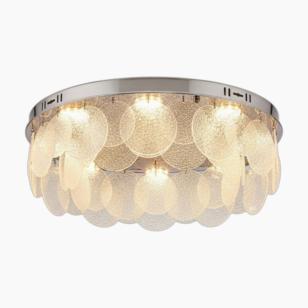 Round chrome-base chandelier with cascading frosted glass discs, emitting soft LED glow. Postmodern elegance.