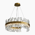 Circular gold chandelier with jagged clear crystals and integrated lights, suspended by three wires.