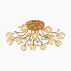 Modern gold crystal chandelier with LED lights, glass flower shades, elegantly floral-inspired design.