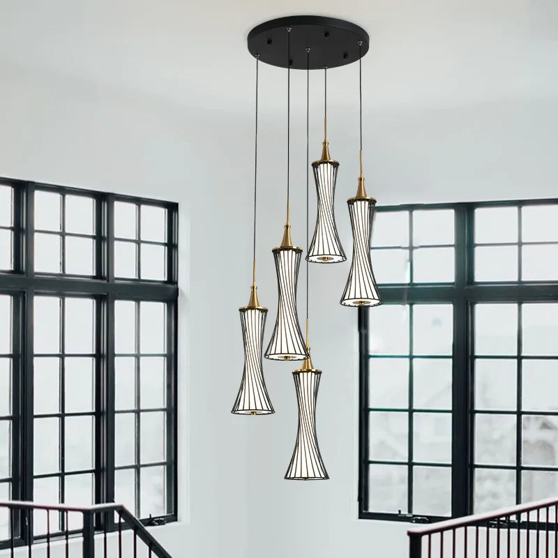 Modern LED crystal chandelier with five hourglass lamps on a sleek black ceiling mount.