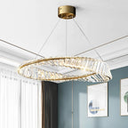 Chic modern chandelier featuring a gold frame and crystal accents, illuminated with integrated LED lighting.