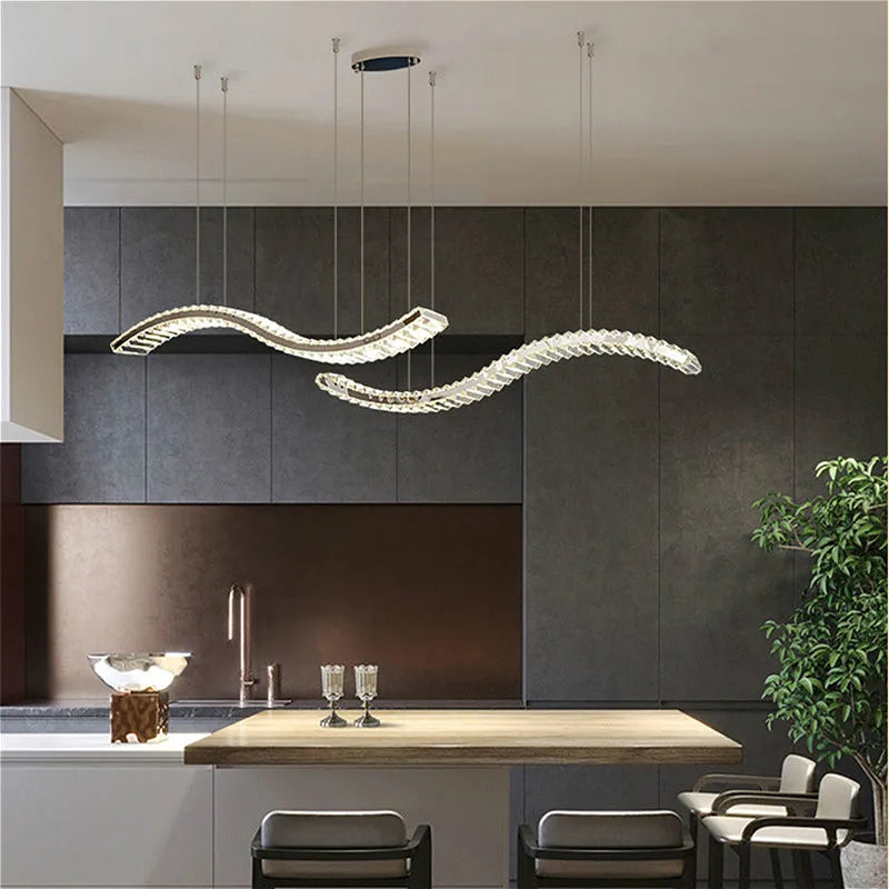 Pair of Maison Ornate Modern Crystal Chandeliers with sleek stainless steel bands, elegantly suspended.