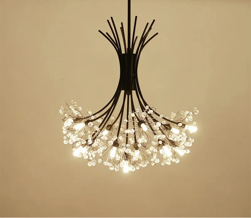 Black metal-armed chandelier with LED-lit crystal clusters, creating a modern blooming floral effect.