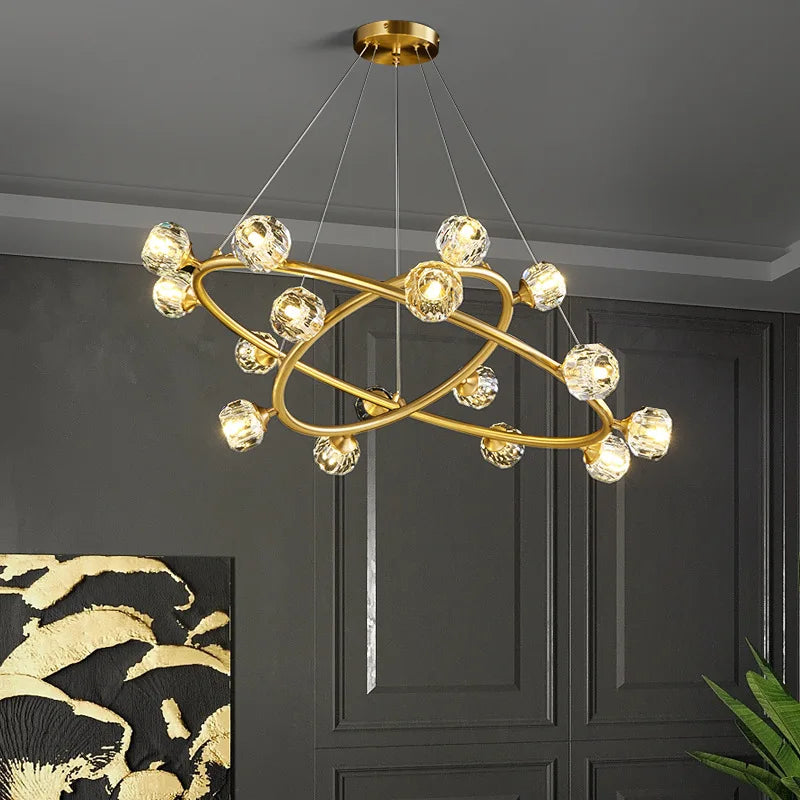 Maison Ornate Nordic minimalist crystal chandelier with intersecting gold rings and glowing glass bulbs.