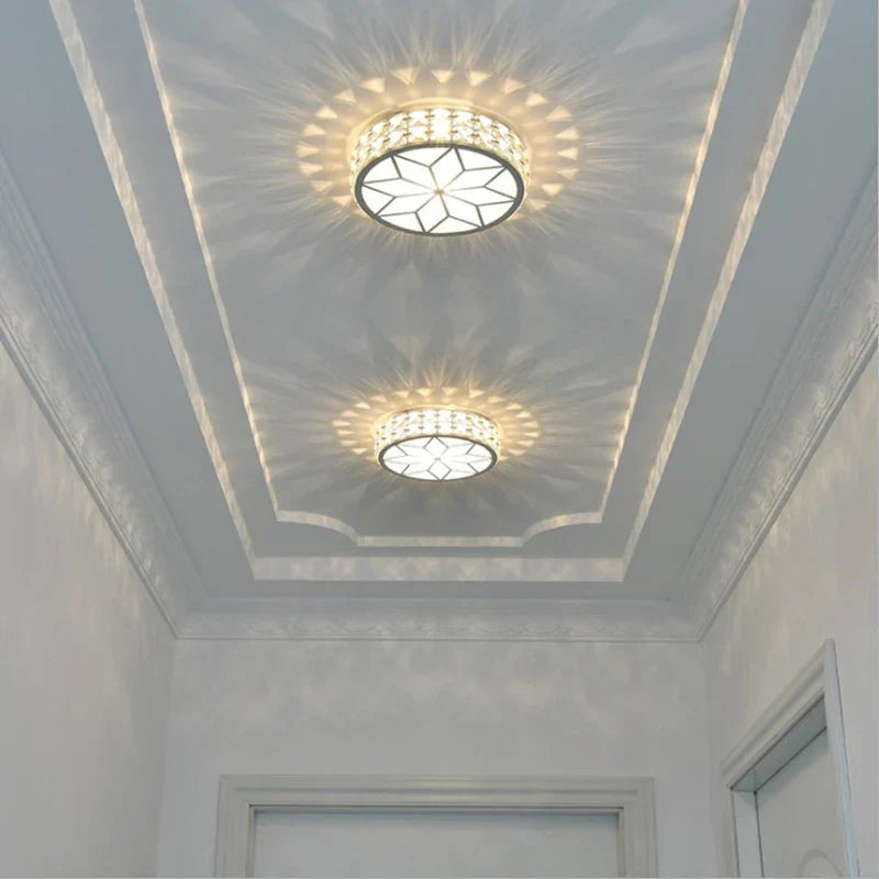 Pair of Maison Ornate Art Deco crystal chandeliers, Nordic gold-black finish, geometric pattern design.