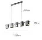Rectangular LED chandelier with five cylindrical crystal shades, suspended by two cords; elegant, modern design.