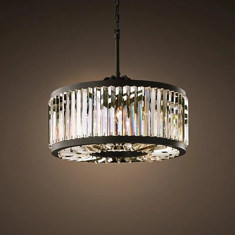 Maison Ornate chandelier with vertical crystal prisms, black frame, chain mount, warm diffused light.