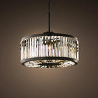 Maison Ornate chandelier with vertical crystal prisms, black frame, chain mount, warm diffused light.